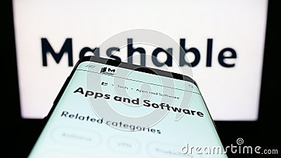 Mobile phone with website of US digital media company Mashable on screen in front of business logo. Editorial Stock Photo