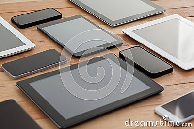 Mobile phones and digital tablets on table Stock Photo