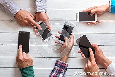 Mobile phones in friends hand Stock Photo