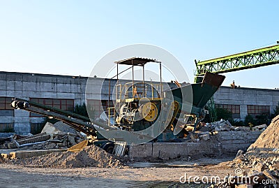 Mobile Stone crusher machine by the construction site or mining quary Editorial Stock Photo