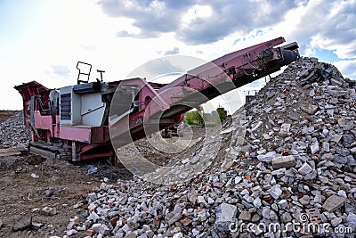 Mobile Stone Jaw crusher machine for crushing concrete into gravel and subsequent cement production. Salvaging and recycling of Stock Photo