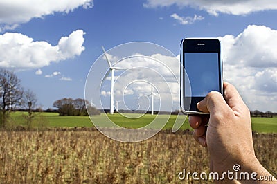 Mobile telephone and wind farm Stock Photo
