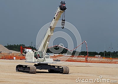 Mobile telescopic crane with tracks in a construction site. Stock Photo
