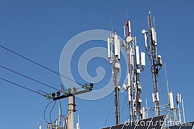 Mobile towers on blue sky background. Many communication equipment Stock Photo
