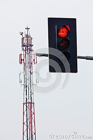 Mobile transmission tower and red traffic lights Stock Photo