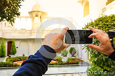 Moblie phone taking picture of traditinal building in India Stock Photo