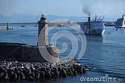Lighthouse and Moby Lines ferry in harbour Editorial Stock Photo