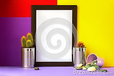 Frame with cacti in metal cans on light violet floor and bright red yellow and violet background for copyspace Stock Photo