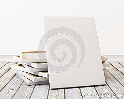 Mock up blank canvas or poster with pile of canvas on floor and wall, background Stock Photo