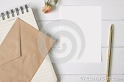 Mock-up blank paper, card. Craft envelope, spiral notebook, golden pen and a rose Stock Photo