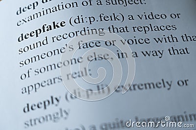 A dictionary page with the word deepfake with selective focussing Stock Photo