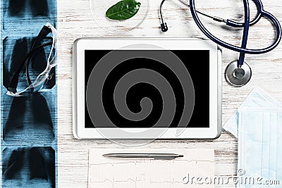 Mock up of doctors desktop with medical supplies Stock Photo