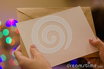 Mock up greeting card in women hand Stock Photo