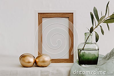 Mock Up Happy Easter. Gold eggs, frame and olive brunch Stock Photo