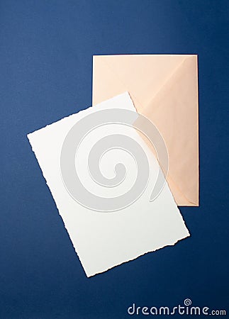 Mock-up for invitations, greetings. On a blue background, a white sheet of paper, an envelope, a notebook, a ring with stones, an Stock Photo