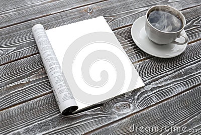 Mock-up magazine on the wooden table. A cup of hot coffee. Stock Photo