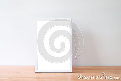 Mock up portrait photo frame on woodden table Stock Photo