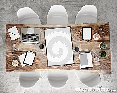 Mock up poster frame on meeting conference table with office accessories and laptop computers, hipster interior background, Stock Photo