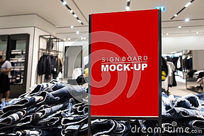 Mock up signboard advertising standing in fashion jeans shop Stock Photo