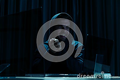 Mock-up template. Hacker in black hood use computer and success in cyber attack through internet Stock Photo