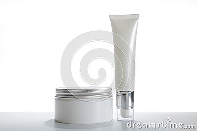 Mock-up two empty container cream pump bottles and a cream jar for skincare is uncover Stock Photo