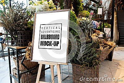 Mock up vertical advertising billboard in frame on wooden stand Stock Photo