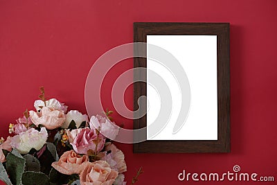 Mock-up wooden photo frame with space for text or picture on red background and flower Stock Photo