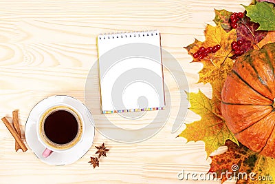 Mockup Autumn flat lay composition. Cup of coffee, opened paper notebook, cinnamon sticks, fallen leaves on white wooden desk. Stock Photo