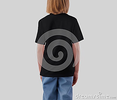 Mockup of a black t-shirt for a girl, back view, fashionable children's streetwear for design, print, pattern Stock Photo