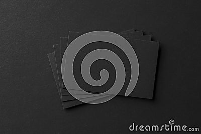 Mockup of business cards fan stack at black textured paper background. Stock Photo