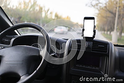 mockup design of the smartphone attached to the windscreen inside the car Stock Photo