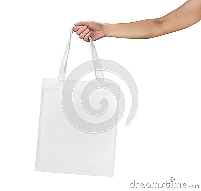 Mockup of female hand holding a blank Tote Canvas Bag isolated on white background Stock Photo