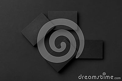 Mockup of four blank business card stacks at black textured background Stock Photo