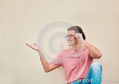 Mockup, hands and happy man pointing to space for advertising, empty and grey wall background. Hand, gesture and guy Stock Photo