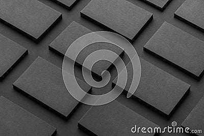 Mockup of horizontal business cards stacks arranged in rows at black textured paper background Stock Photo