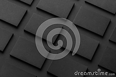 Mockup of horizontal business cards stacks arranged in rows at black textured paper background Stock Photo