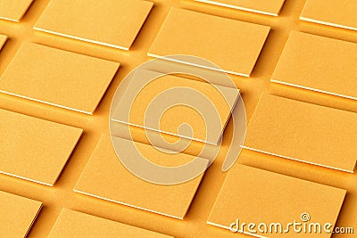 Mockup of horizontal golden business cards stacks at textured paper background. Stock Photo