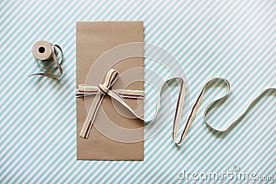 Mockup image of Blank Craft Envelope tied with Fabric Ribbon. Fl Stock Photo