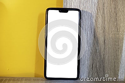 Mockup image of mobile phone with blank white full screen in a orange pattern. Stock Photo