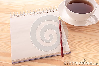 Mockup image. Open blank page notebook with a copy space and cup of tea on a white wooden table background. White paper of Stock Photo