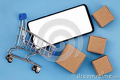 Mockup image of smartphone with the blank white screen with a place for the advertised text in shopping cart and cardboard boxes Stock Photo