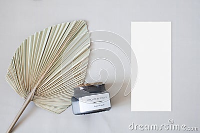 Mockup menu card with leaf palm and candle on the nude fabric Stock Photo