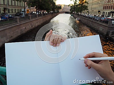 Mockup of person hand holding blank white notebook preparing to write down his or hers ideas. Stock Photo