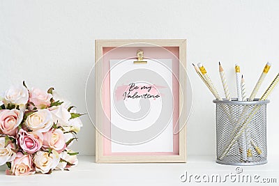 Mockup Picture frame and pink roses. Valentines Day Background concept with copy space. Mock up with photo frame and flowers with Stock Photo