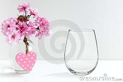 Mockup - stemless wine glass, next to blossom in a vase Stock Photo