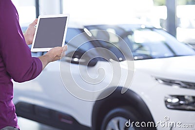 Mockup of tablet of car seller in dealing salon with extravagance vehicles Stock Photo