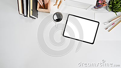Mockup tablet, coffee and office supply on white office desk with top view Stock Photo
