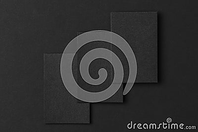 Mockup of three vertical business cards at black textured paper Stock Photo