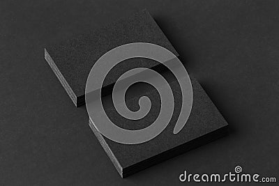 Mockup of two blank business cards stacks at black textured paper Stock Photo