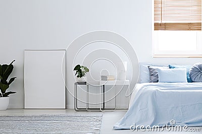 Mockup of white empty poster in simple hotel bedroom interior wi Stock Photo